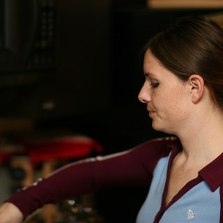 Woman in Profile Reaching Forward in Kitchen