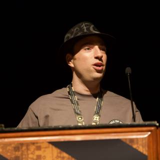 Man in Hat Delivers Powerful Speech at Defcon Podium