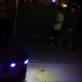 Coco Delivery Robot Navigates Nighttime Festival Crowd