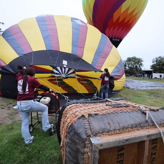 Volunteer Crew Inflating Hot Air Balloons at Dawn