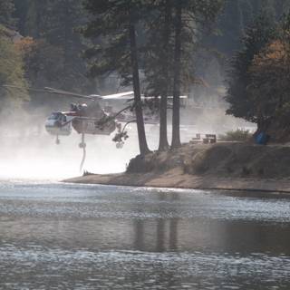 Firefighting Helicopter Sprays Water on Lake