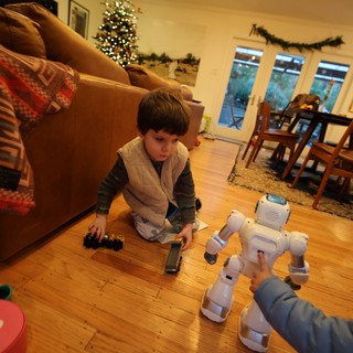 Child Playing with Robot Toys on Christmas Eve