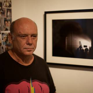 Man Standing in Front of a Portrait