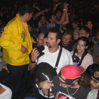 Yellow Jacket Man in the Midst of a Nightlife Crowd
