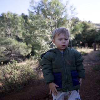 Young Explorer on a Sunlit Mountain Trail