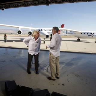 Richard Branson and Companion in Front of White Knight Two at Airfield