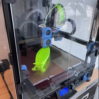 3D Printer Creating a Green Toy
