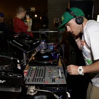 Green-Hatted DJ Mixing Music with Headphones