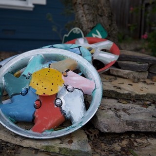 Broken Colorful Toy Clock in Backyard Garden