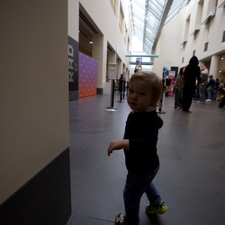 Toddler Exploring Modern Museum Atrium Space