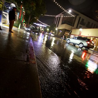 Rainy Night Street Scene with String Lights