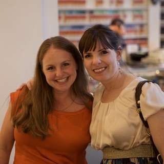 Two Women Smiling at a Wine Party Event