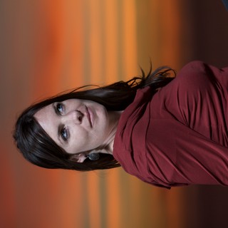 Woman Gazing Skyward Against a Fiery Sunset