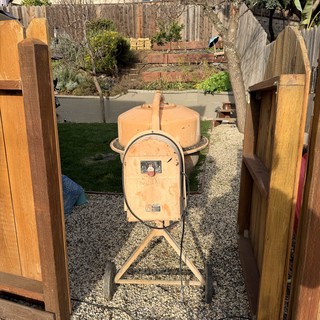 Vintage Orange Cement Mixer in Suburban Backyard