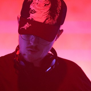 DJ Lost in the Mix Under Red Neon Glow