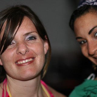 Two Smiling Women Posing Together at Social Event