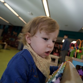 Young Child Reading Picture Book in Classroom