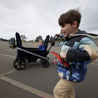Young Boy Playing with Toy at Outdoor Parking Lot