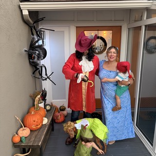 Family Peter Pan Halloween Costume on Decorated Porch
