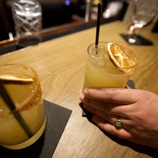 Margaritas with Dried Orange Garnish at Bar
