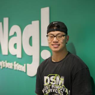 Ning Zetao Rocks the Classic Hat and T-Shirt Combo in front of WAG Logo
