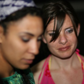Two Women Share a Close Moment at Night Event