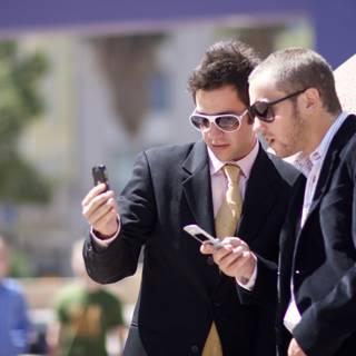 Businessmen Busy with Electronics