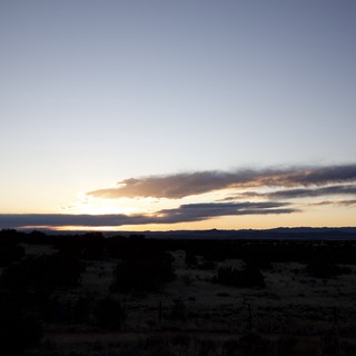 Dramatic Desert Sunset Over Distant Mountain Range