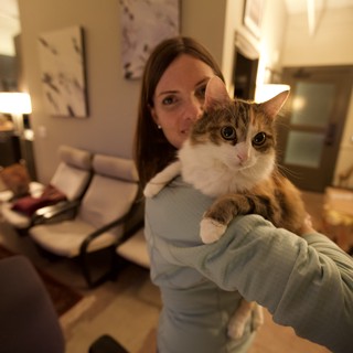 Woman Proudly Presents Fluffy Cat to Camera