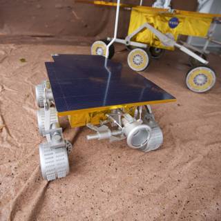 Model Rover with White Object on Plywood Ground