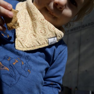 Child Proudly Displays Handmade Smiley Face Cloth