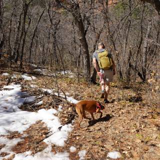 A Man and His Canine Companion Take a Wintery Hike