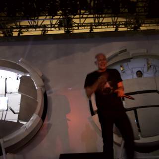 Man on a Stage with a Stunning Sphere Screen