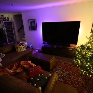 Cozy Christmas Living Room with Illuminated Tree and Ambient Lighting