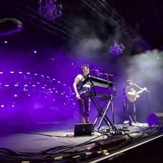 Rocking the Crowd: Duo on stage with Purple Lights