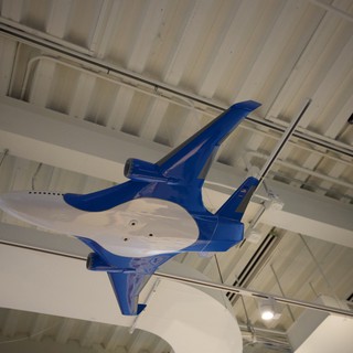 Blue Fighter Jet Model Suspended from Museum Ceiling