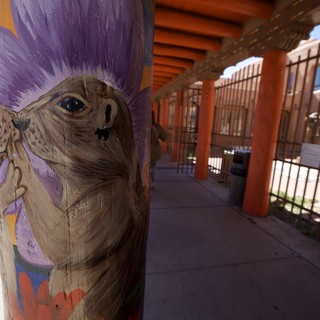 Painted Wooden Post with Purple-Haired Character at Adobe Portal