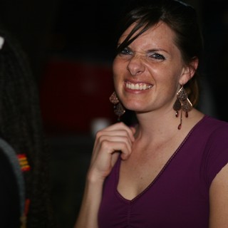 Joyful Woman Smiling at Evening Social Gathering