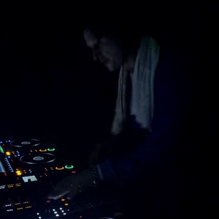 DJ Performing with Pioneer Equipment in Dark Club