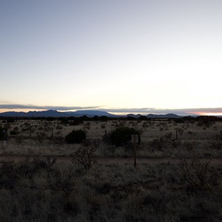 Desert Twilight Over Distant Mountain Ranges