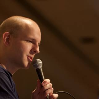 Bald Entertainer Performing with a Microphone