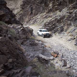 White SUV Takes on Narrow Canyon
