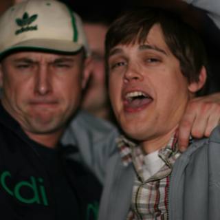 Grey Jacketed Man with Baseball Cap