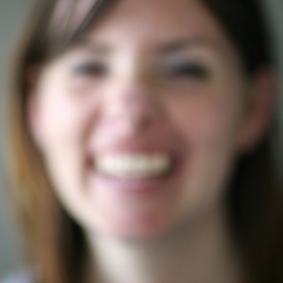 Blurred Portrait of a Smiling Young Woman