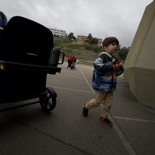 Young Boy Walking on Campus Promenade