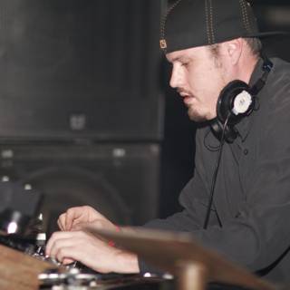DJ Travis B rocks the turntables in his signature cap