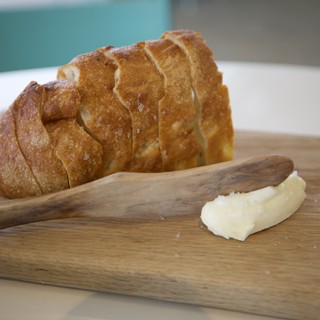 Artisan Bread with Butter on Wooden Board