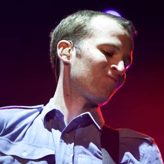Blue Shirted Chris Baio Electrifies the Stage with his Music