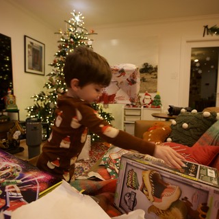 Child Opening Christmas Presents on Holiday Morning