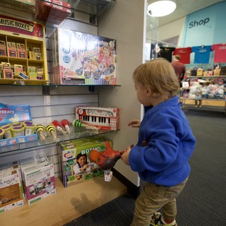 Young Child Browsing Music Toys at Museum Gift Shop